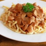 Meat with mushrooms in creamy sauce