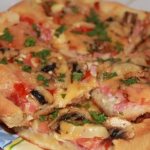 Pizza with sausage and champignons
