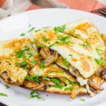 Scrambled eggs with mushrooms, champignons, tomatoes, cheese. Recipe 